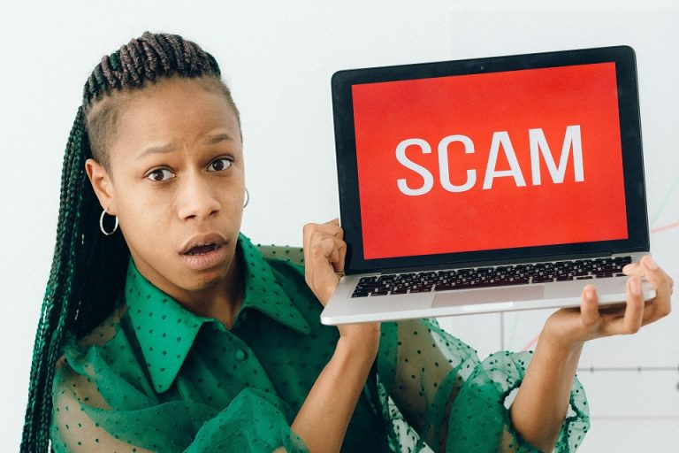 a girl with a SCAM sign