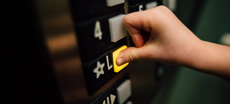 someone facing the High-rise moving challenges in Toronto in an elevator