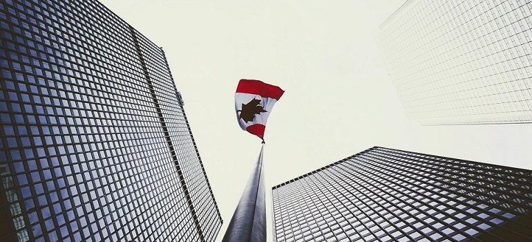 a Canadian flag on a high building 