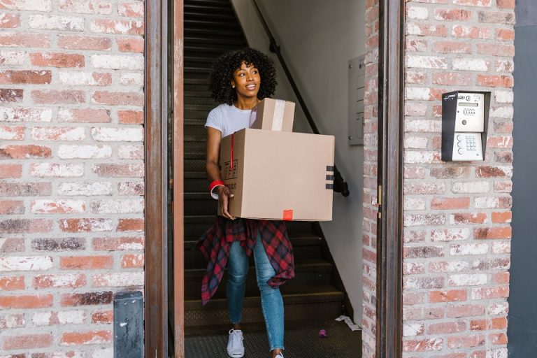 a girl carrying a moving box