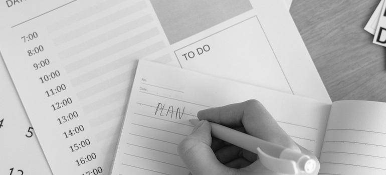 someone writing a moving plan 