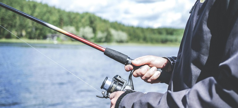 a man doing one of the things you can do near Lake Ontario, fishing