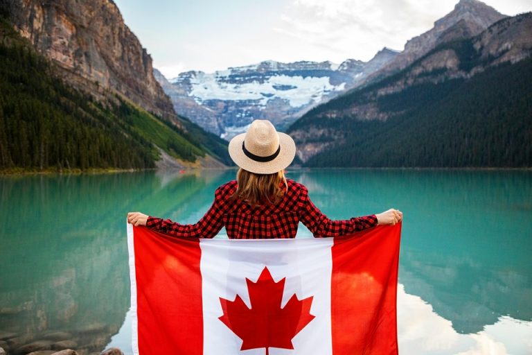 a girl in nature holding a Canadian flag