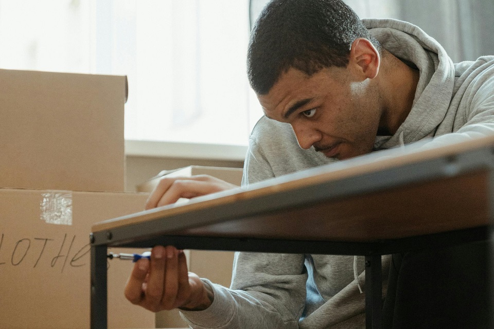 a man handling a piece of furniture
