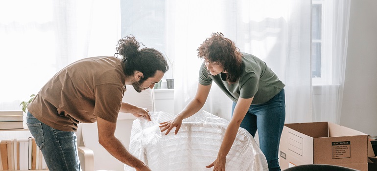a couple moving with the help of residential movers Canada trusts