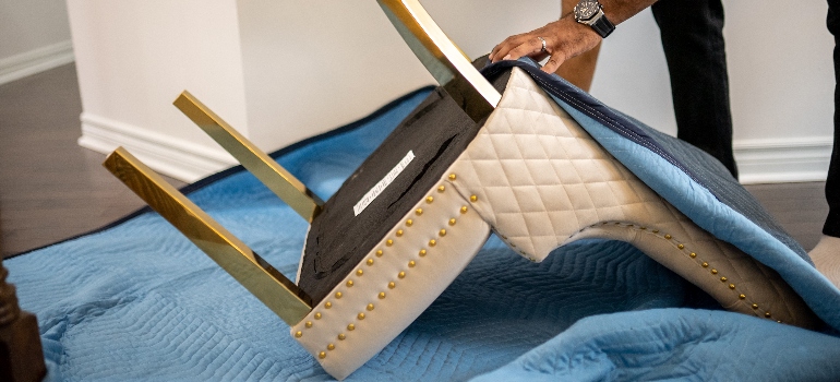 a mover wrapping a chair
