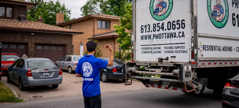 a mover standing next to a truck 