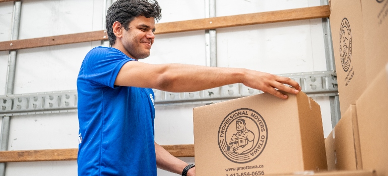 one of the commercial movers Canada carrying a box 