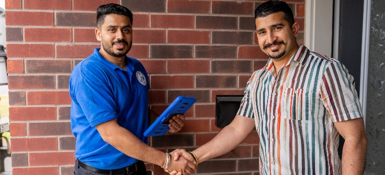 one of the local movers Canada and a client shaking hands 