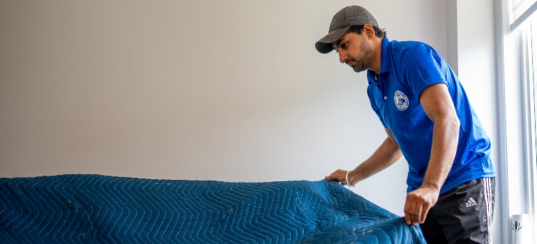 a mover covering a couch