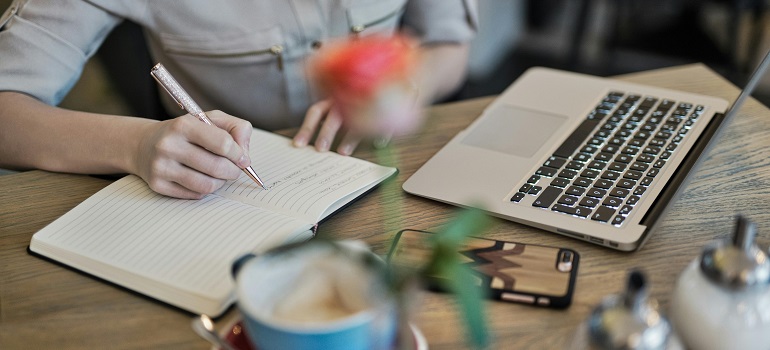 a woman taking notes on moving your office