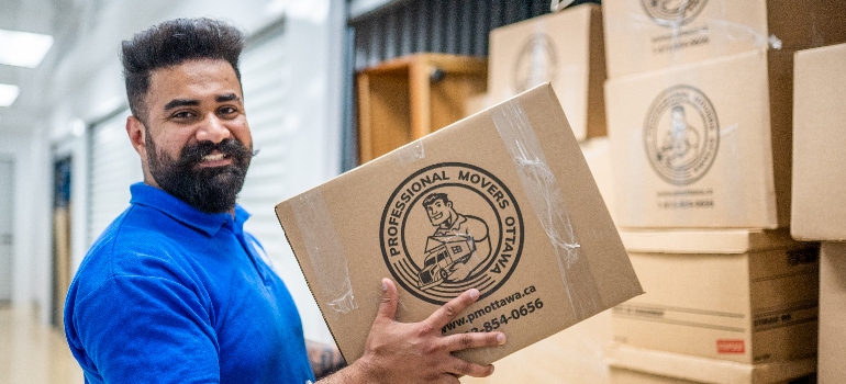 one of the movers Aurora carrying a box