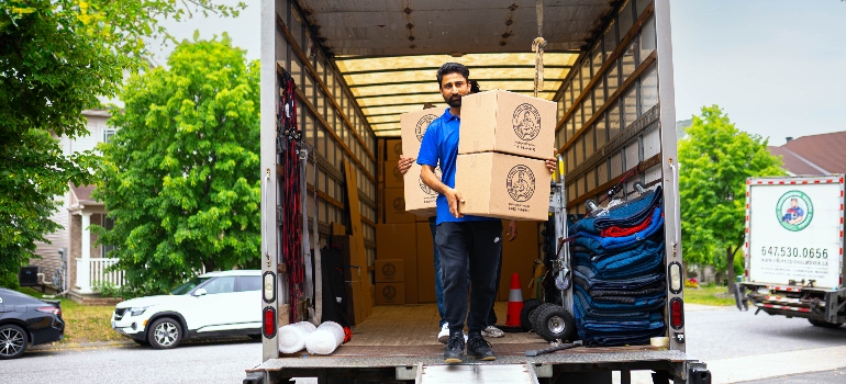 one of the movers Ajax unloading a truck