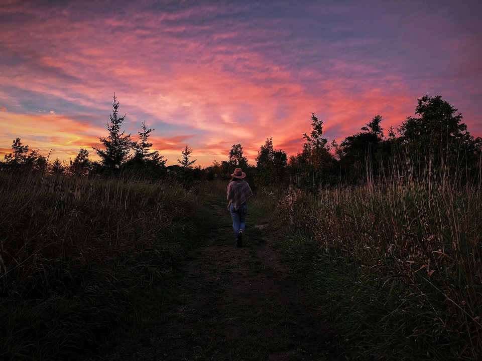 a young woman on a road in Aurora