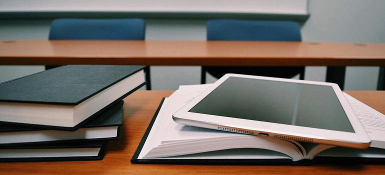 books on a desk in a classroom 