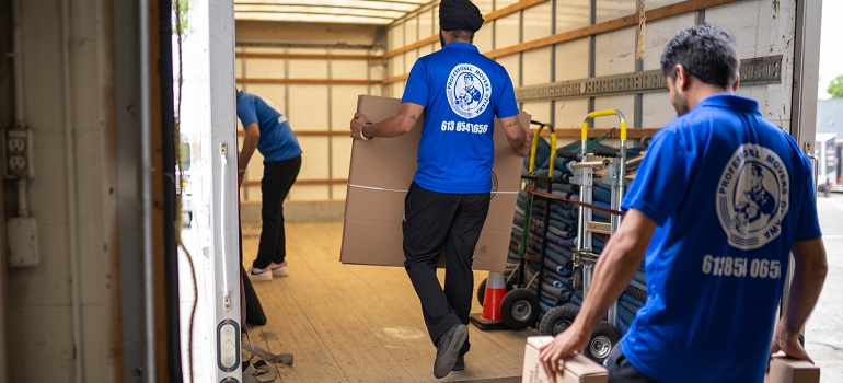 a group of movers in Durham loading items into a moving truck 