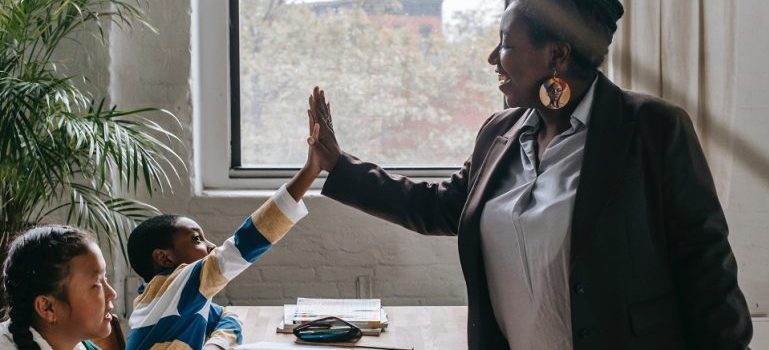 a teacher and a student high fiving in one of the top schools in Richmond Hill