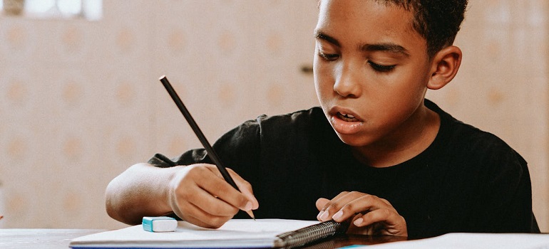 a student writing notes in one of the Top schools in Richmond Hill