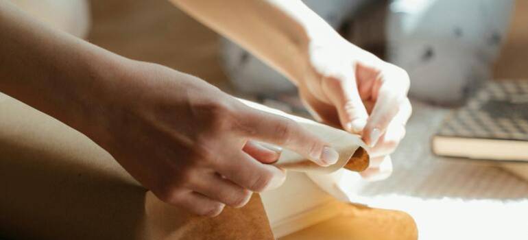 a young woman folding papers