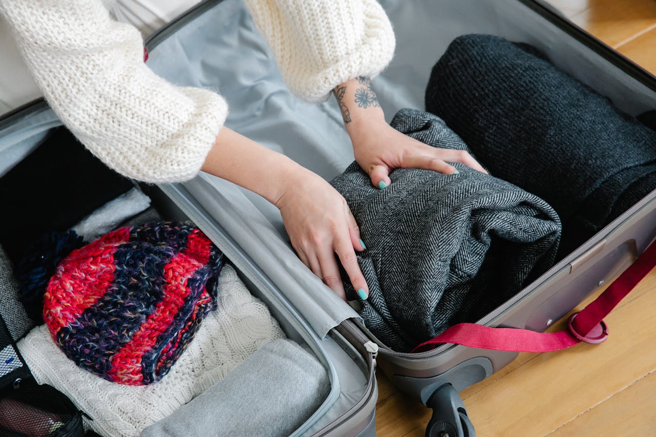 a girl packing winter clothes