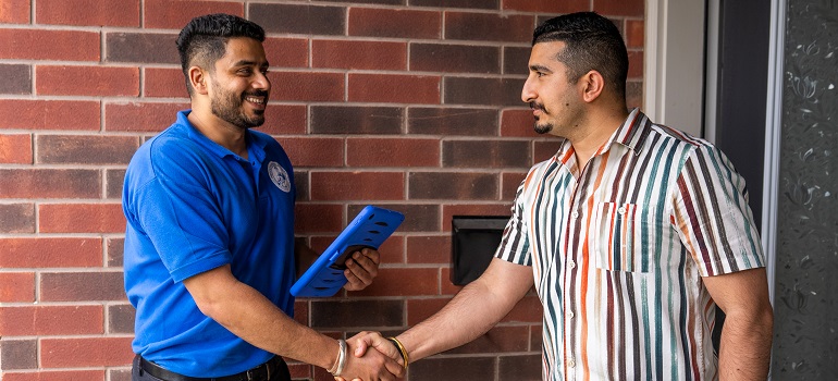 a representative of our Keswick moving company shaking hands with a client