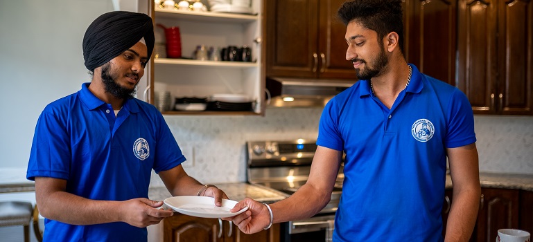 a couple of workers from a moving company in Cambridge shaking hands
