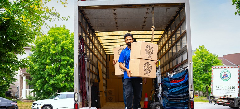 one of the Kleinburg movers carrying moving boxes