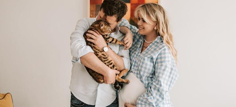 Couple holding cat indoors
