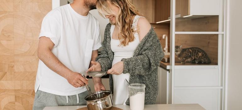  Couple cooking together in kitchen in one of the top Ontario locations for expecting parents