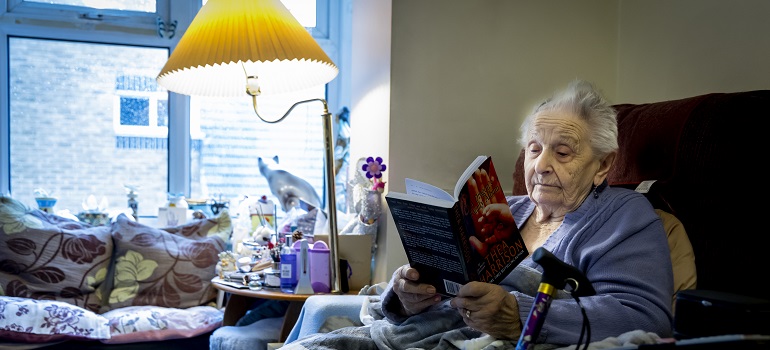 an old woman reading a book