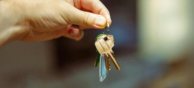 Handing over house keys, contract in background.