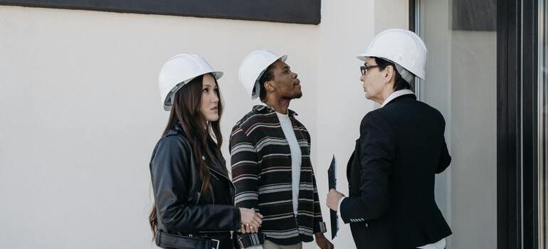 Real estate team discussing project outside a building