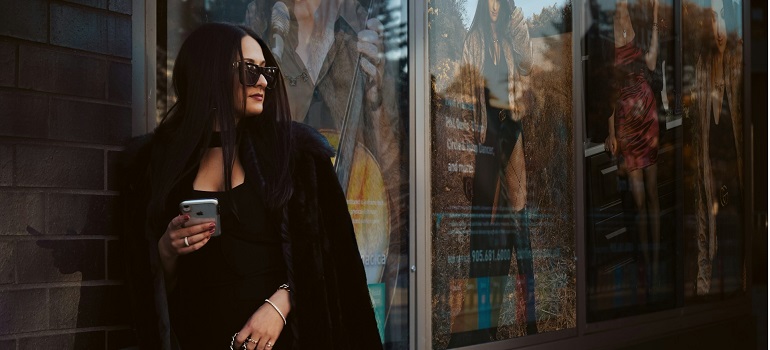 a woman living in Burlington in 2025, walking down a street
