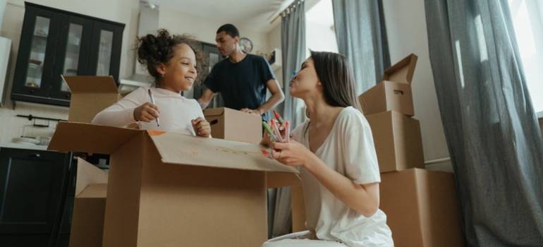 a family packing moving boxes