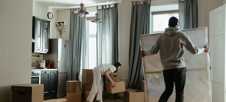 a couple packing a living room