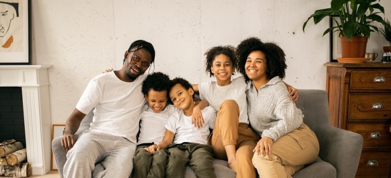 a family sitting on a couch 