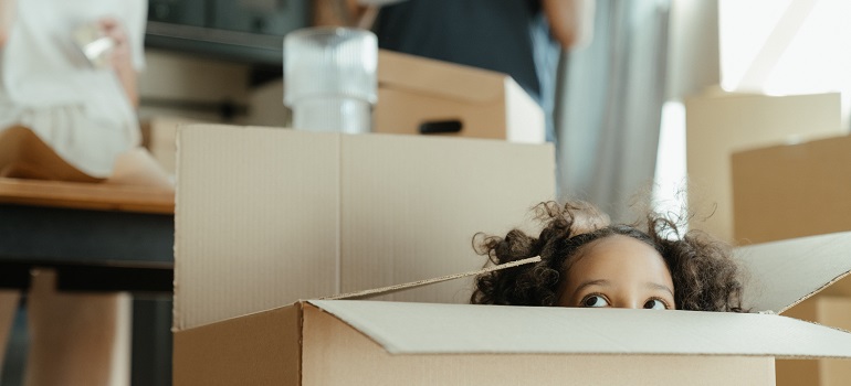 a kid in a moving box, playing