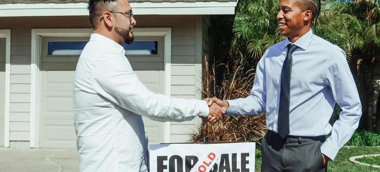 a man asking a real estate agent: living in Oshawa still affordable in 2025