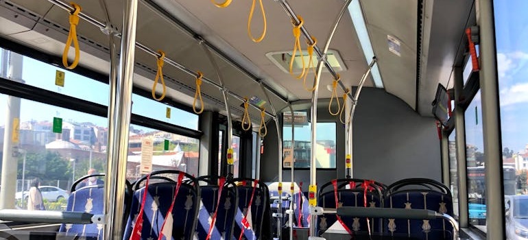 Interior of a city bus on a sunny day.