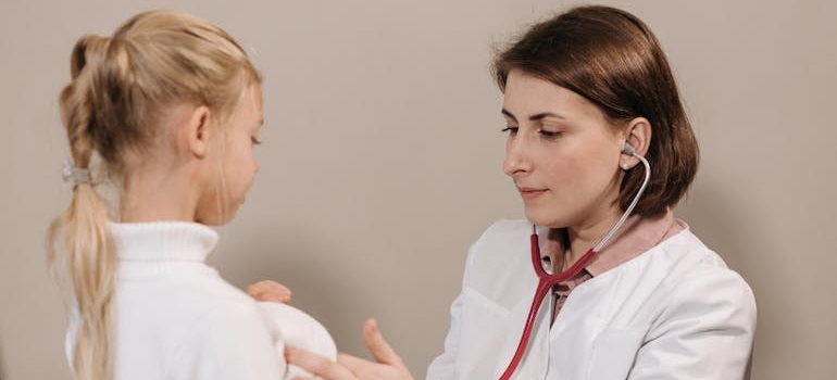 a kid being examined by a doctor