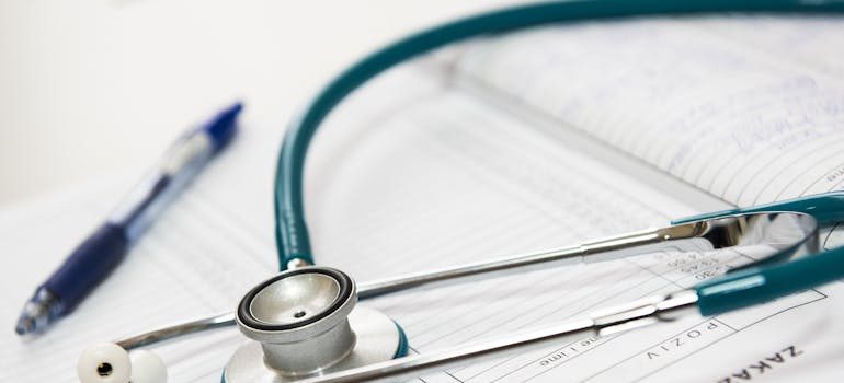 Medical stethoscope on healthcare insurance documents