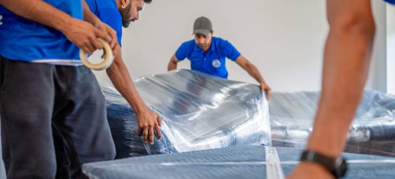 Team wrapping equipment with stretch film and padding