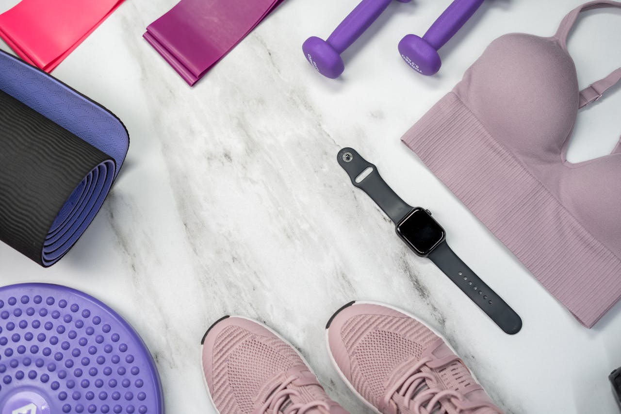 belongings of a someone who is peparing gym equipment for storage including mats and resistance bands