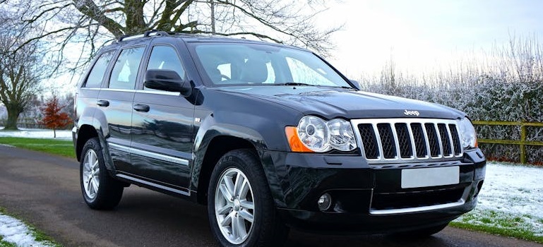 Jeep Grand Cherokee, one of the popular car models in Toronto on a winter road.