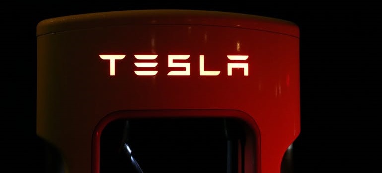 Tesla charging station with illuminated logo.