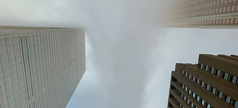 Skyscrapers viewed from below on a foggy Toronto day