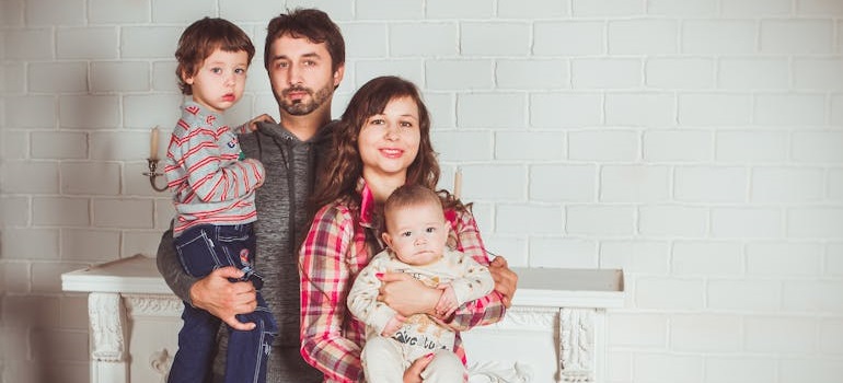 appy family posing together indoors in a cozy family-friendly suburban neighborhood.