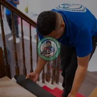 Uniformed movers in Bradford securely loading furniture onto a truck for a local residential relocation.