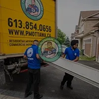 Uniformed crew loading a transport truck efficiently to showcase the reliability of our professional Caledon Movers.